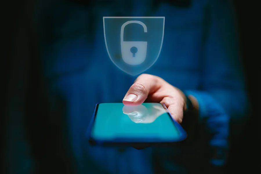 Somebody logging in securely on their phone using their thumbprint.